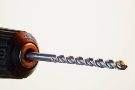 Electric drill and bit in close-up with shallow depth of field  36 mp image against white  Logos removedの写真素材