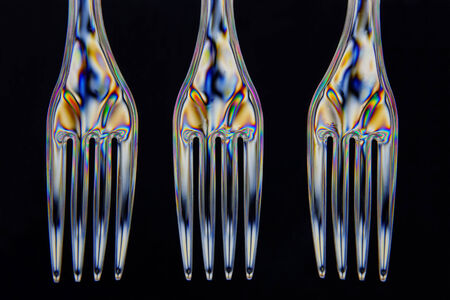 Plastic forks taken with double polarrised light in closeup