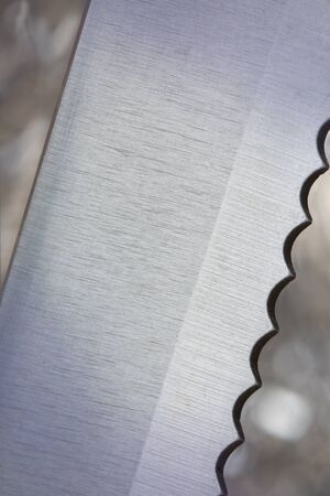 Close up of the edge of a serrated bread knife. On a knife edge concept.の写真素材