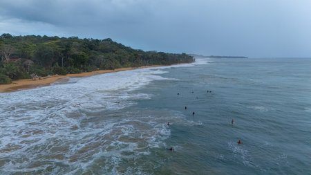 Drone Aerial view at sunrise of some surfers at the beautiful Bluff Beach in the island Isla Colon, Bocas de Toro, Panamaの写真素材