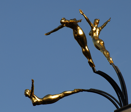 Three Golden figures diving off the Trocadero centre in Londonの写真素材