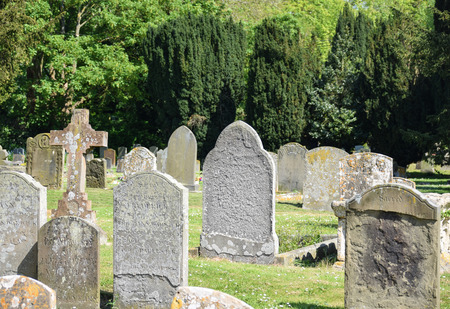 Sutton Courtney, United Kingdom - May 07 2018:   Some of the ancient garvestones in the graveyard of All Saints Churchのeditorial素材