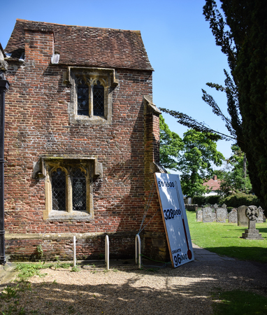 Sutton Courtney, United Kingdom - May 07 2018:   A painted thermometer showing how much money has been raised in a church Appeal ouside ALl Saints Churchのeditorial素材