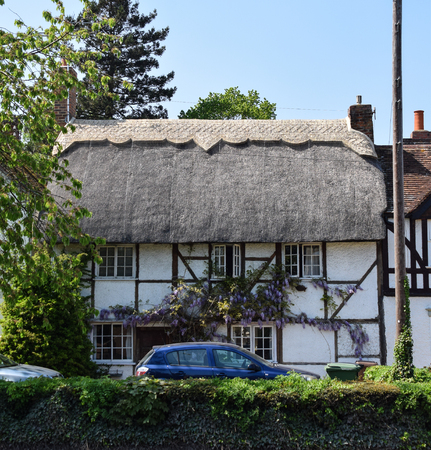 Sutton Courtney, United Kingdom - May 07 2018:   A cottage with a straw thatched roofのeditorial素材