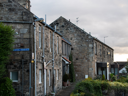 Linlithgow, United Kingdom - August 10 2018:   A row of stone cottages on Canal Terrace
