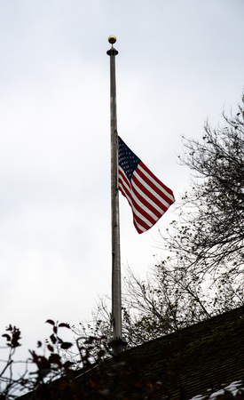 The United States flag being flown at half mast in Central Park in memory of the lives lost in the California wild fires of 2018の写真素材