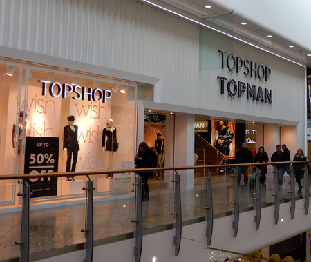 Reading, England - December 01 2017:   Shoppers passing Top Man in The Oracle shopping centre.のeditorial素材