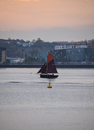 November 01 2017;  Cardiff Wales.  A yacht sailing past a buoy on Cardiff Bayのeditorial素材