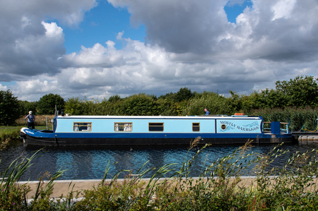 Falkirk, United Kingdom - August 09 2018:   A Narrowboat named Mostly Harmless tied up on the bank of the Forth and Clyde canal at the Helixのeditorial素材