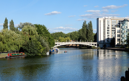 Reading, United Kingdom - June 21 2018:   The River Thames as it goes through Reading, passing under Reading Bridge and by some office buildingsのeditorial素材