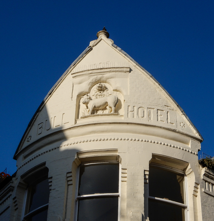 Reading, United Kingdom - April 20 2018:   The sign of the now defunct Bull Hotel, carved into the eaves of the roof.のeditorial素材
