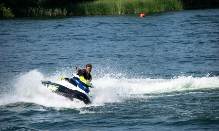 Reading, United Kingdom - July 07 2018:   A Jet Skier takes a sharp turn at Lagoona Aqua Parkのeditorial素材