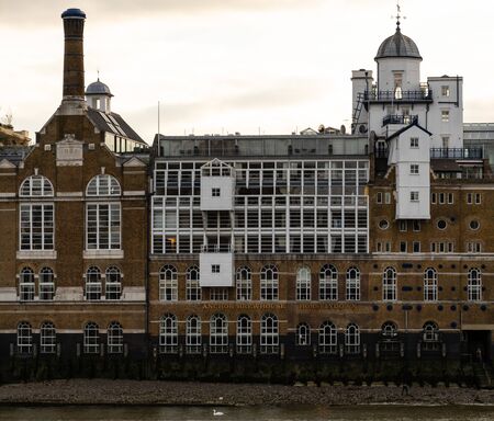 London, United Kingdom - October 18 2018:   The front of the Anchor Brewhouse building on the Southbank, over looking the River Thames. Formerly a brewery, now luxury flats and restaurantsのeditorial素材