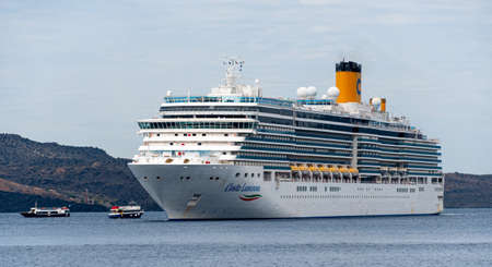 Fira, Greece - July 16 2019:   The Itailan based Cruise ship Costa Luminosa anchored in the Aegean...