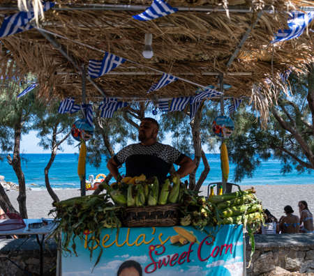 Perissa, Greece - July 18 2019:   A street corn stall and seller on Perissa Sea front roadのeditorial素材