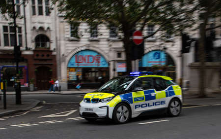 London, United Kingdom - August 18 2019:  Metropolitan Police with blue lights flashing speeds along Haymarketのeditorial素材