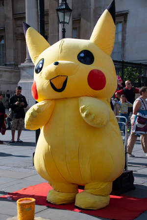London, United Kingdom - August 18 2019:  A person dressed in an inflatable Pikachu costume to entertain Pokemon fans outside the National Gallery in trafalgar Squareのeditorial素材