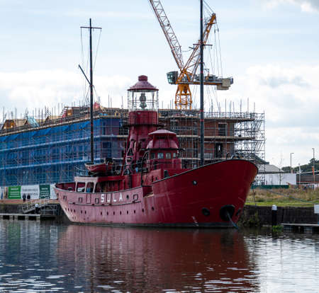 Gloucester, United Kingdom - September 08 2019:  The lightship Sula moored in front of building works on the Gloucester and Sharpness Canalのeditorial素材