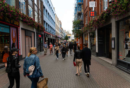 London, United Kingdom - August 18 2019:  Shoppers and tourists throng along London's famous Carnaby Street shopping laneのeditorial素材