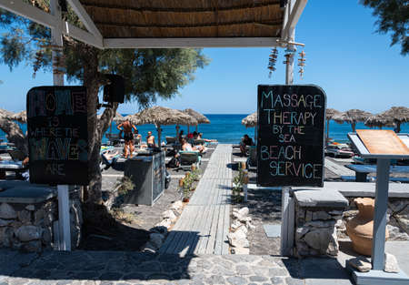 Perissa, Greece - July 18 2019:   The entrance to Waves Beach Bar on Perissa Sea frontのeditorial素材