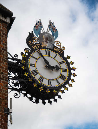 Wotton-Under-Edge, United Kingdom - September 07 2019:   An ornate hanging clock celebrating Queen Victoria's Diamond Jubilee in 1897 on Market Streetのeditorial素材