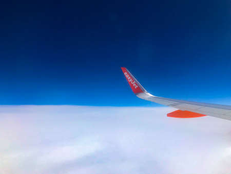 Bognor Regis, United Kingdom - July 10 2019:   The wingtip of an EasyJet plane as it flies over...