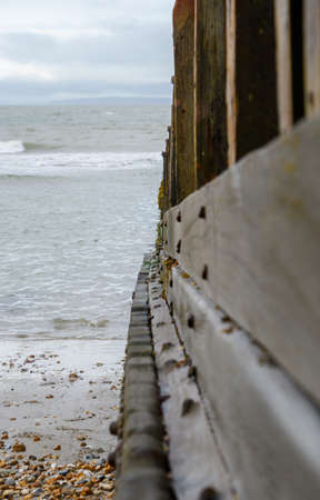 A view along a wooden groyne to the waters of the English Channel at West Wittering