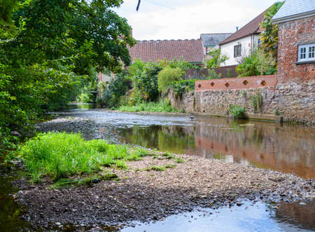 The river Lowman flows past houses in Tivertonの写真素材