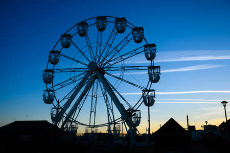 Hastings Ferris wheel silhouetted against the sunsetの写真素材