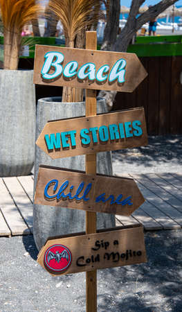 Perissa, Greece - July 11 2019:   A sign showing directioons to the beach or a bar on Perissa sea...