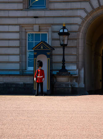 London, United Kingdom - July 30 2020:  A Gurdsman stood to attention at his post outside of Buckingham Palaceのeditorial素材
