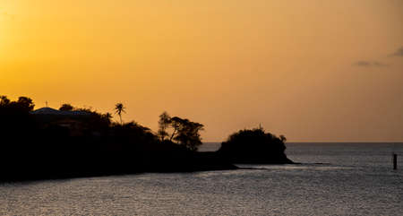 The sun setting behind the island of St Luciaの写真素材