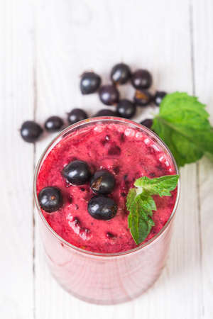 Smoothie in a glass and fresh currantsの写真素材