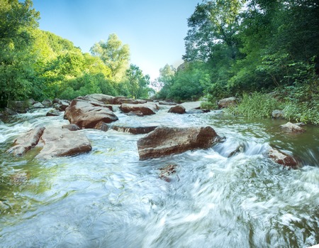 mountain river flowing between rocksの写真素材