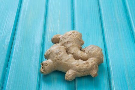 a ginger root lies on the wooden tableの写真素材