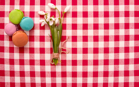 Colorful pasta or almond cookies on a red checkered tableclothの写真素材