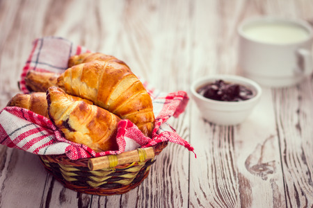 Delicious croissants with jam on a wooden background. Breakfast conceptの写真素材
