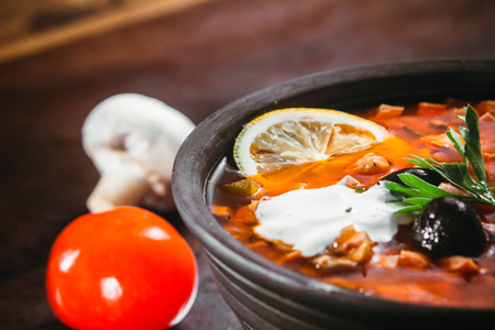 Traditional Russian soup solyanka closeup in a bowl on the table.の写真素材