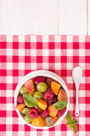 salad in a plate of fresh fruits and berriesの写真素材