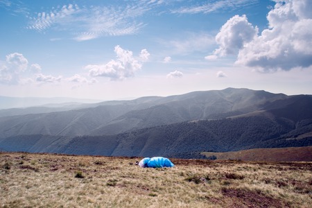 paraglider flies. paraglider over the tops of the mountains in summer sunny day.の写真素材