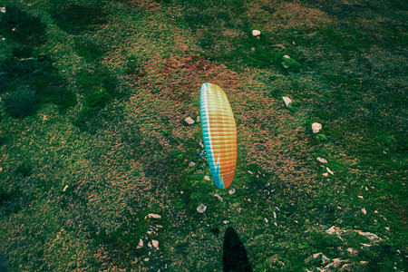 paraglider flies. paraglider over the tops of the mountains in summer sunny day.の写真素材