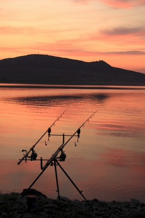 Reservoir of Nove Mlyny at sunset with fishing rods in the foreground  Southern Moravia, Czech Republic の写真素材