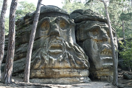 Devil\'s Heads - work of the sculptor Vaclav Levy carved into the sandstone rocks in the first half of the 19th century near village Zelizy in Czech Republic.の写真素材