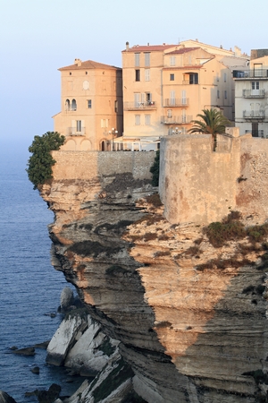 Sunrise at the limestone cliffs and buildings in Bonifacio, Corsicaの写真素材