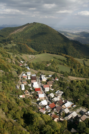 Village in the White Carpathians. The picturesque village vr?atsk? podhradie on the border of Slovakia and the Czech Republic, known for ITS ruins of the castle towering above the village.の写真素材