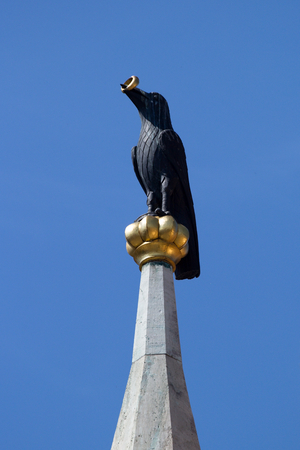 Raven holding a golden ring - and roof detail on a church spire of the Matthias Church in Budapest, Hungaryの写真素材