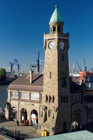 Clock Tower of the famous Hamburger Landungsbruecken with a commercial harbor and Elbe river, St. Petersburg. Pauli district, Hamburg.のeditorial素材