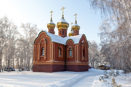 Old Orthodox church in Siberia in the middle of a snow-covered fieldの写真素材