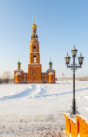 An old orthodox church in winter in a snowy fieldの写真素材