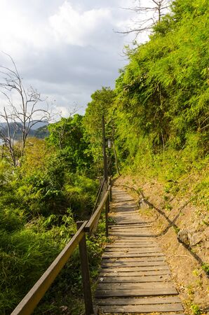 Wooden path on the cliff by the sea in Thailandの写真素材